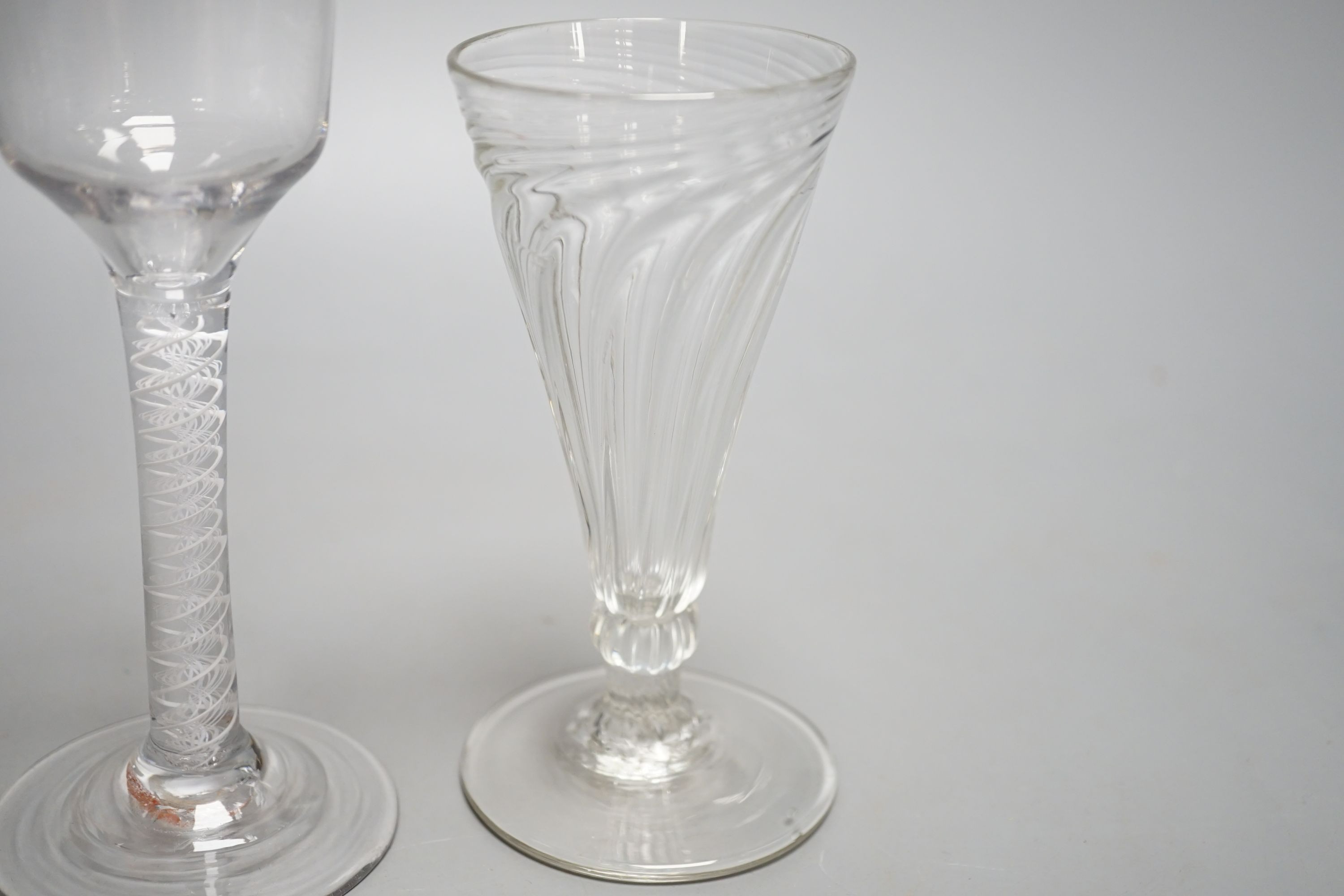 A George III opaque twist stem cordial glass, a George II cordial glass with folded foot and a wrythen twist ale glass (3) - tallest 15cm